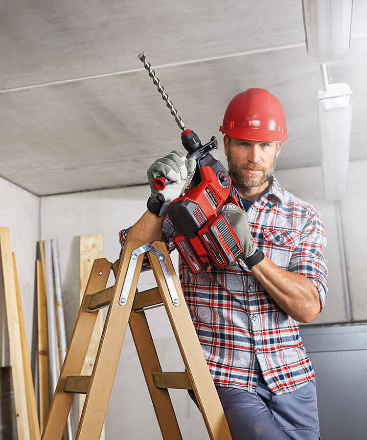 A man is currently working with an impact drill