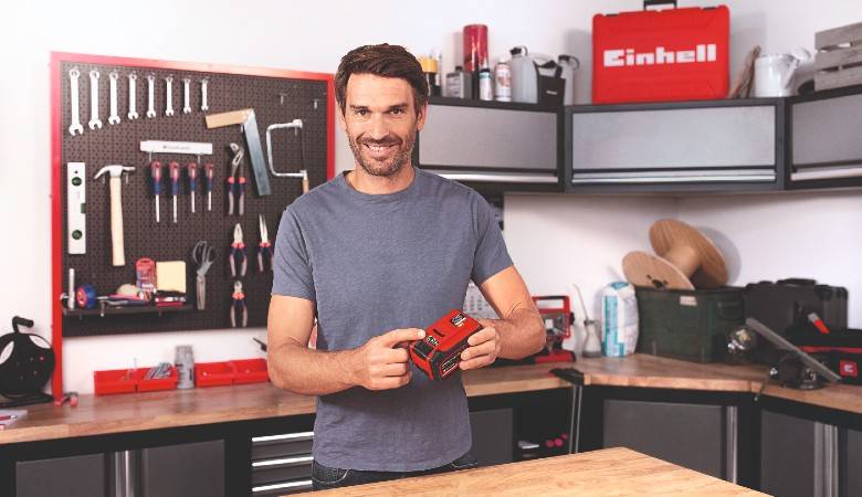 A man is working on a workbench