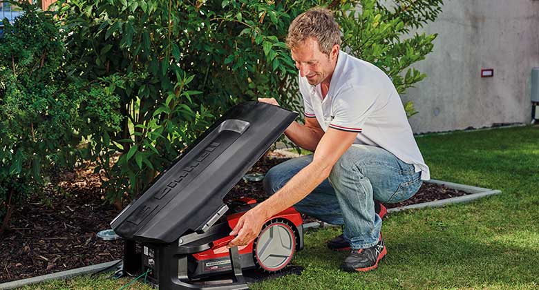 man fixes roof for lawn mower