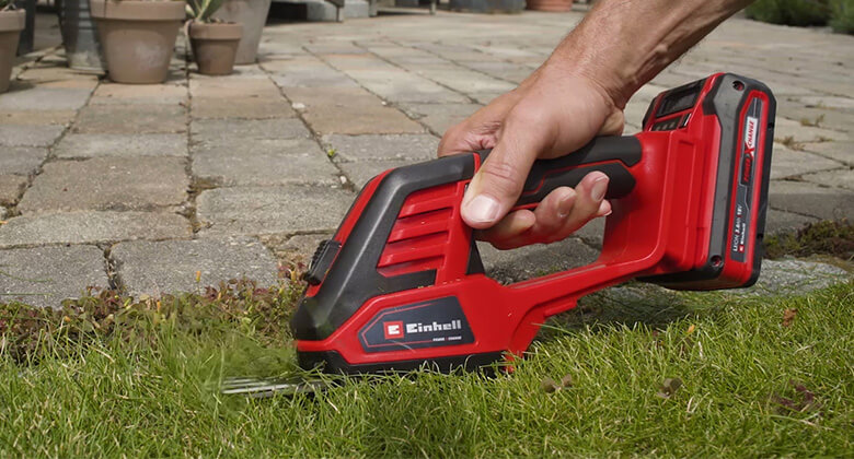 A person uses the Einhell grass shear