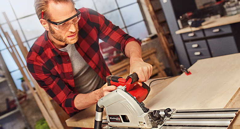 A man is working with a plunge saw